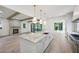 Open concept kitchen with a large island, pendant lighting, marble countertops, and stainless steel appliances at 114 Terrace Ne Dr, Atlanta, GA 30305