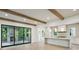 Open concept kitchen with a large island, pendant lighting, and exposed wooden beams at 114 Terrace Ne Dr, Atlanta, GA 30305