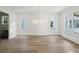 Spacious living area with hardwood floors, ample natural light, and modern chandelier at 114 Terrace Ne Dr, Atlanta, GA 30305