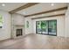 Bright living room featuring exposed wooden beams, stone fireplace, and sliding doors to a porch at 114 Terrace Ne Dr, Atlanta, GA 30305