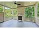 Covered porch with a brick fireplace overlooking a lush backyard at 114 Terrace Ne Dr, Atlanta, GA 30305