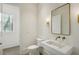 Elegant powder room with floating sink, designer mirror, and modern fixtures at 114 Terrace Ne Dr, Atlanta, GA 30305