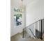 Bright staircase features hardwood steps, black railings, and a modern pendant light at 114 Terrace Ne Dr, Atlanta, GA 30305