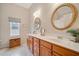 Bathroom with double sinks, vanity, round mirrors, and stylish fixtures offering a clean and modern look at 128 Holly Pl, Canton, GA 30115