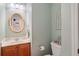 Cozy half bathroom featuring a pedestal sink and decorative mirror at 128 Holly Pl, Canton, GA 30115