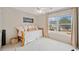 Bright bedroom with a large window, daybed, and white carpet for a cozy and inviting space at 128 Holly Pl, Canton, GA 30115