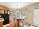 Cozy dining area featuring hardwood floors, a table for six, and a view into the backyard at 128 Holly Pl, Canton, GA 30115