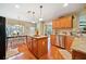 Bright kitchen featuring granite countertops, wood cabinets, stainless dishwasher, and island at 128 Holly Pl, Canton, GA 30115