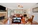 Inviting living room featuring a brick fireplace, ceiling fan and natural light at 128 Holly Pl, Canton, GA 30115