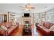 Elegant living room with hardwood floors, a cozy fireplace, and stylish sofas creating a warm and inviting atmosphere at 128 Holly Pl, Canton, GA 30115