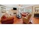 Comfortable living room with brick fireplace, hardwood floors, and large windows at 128 Holly Pl, Canton, GA 30115