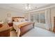 Comfortable main bedroom with a tray ceiling, large window, and neutral tones for a peaceful retreat at 128 Holly Pl, Canton, GA 30115