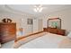 Well-appointed main bedroom with a glimpse into the en-suite bathroom and classic wood furnishings at 128 Holly Pl, Canton, GA 30115