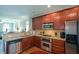 Modern kitchen featuring stainless steel appliances, granite countertops, and ample cabinet space for storage at 6422 Paulson Pl, Sandy Springs, GA 30328