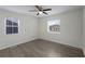 Bright bedroom features neutral walls, wood-look flooring, and a modern ceiling fan with great natural light from two windows at 17 Turman #4 Se Ave, Atlanta, GA 30315