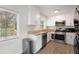 Updated kitchen with stainless steel appliances, stone countertops, and natural light at 17 Turman #4 Se Ave, Atlanta, GA 30315