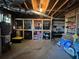 Unfinished basement with storage shelves, concrete floor, and visible ceiling structure at 25 Clay Ct, Hiram, GA 30141