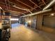 Spacious unfinished basement featuring exposed ceiling and structural elements with lighting at 25 Clay Ct, Hiram, GA 30141