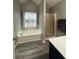 Bright bathroom featuring a luxurious soaking tub, a shower, and views of the landscape at 25 Clay Ct, Hiram, GA 30141