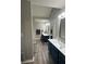 Stylish bathroom boasts double sinks, modern vanities, and wood flooring at 25 Clay Ct, Hiram, GA 30141