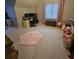 Bright bedroom featuring a workspace, pink rug, and natural light from the large window at 25 Clay Ct, Hiram, GA 30141