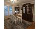 Dining room features traditional table with china cabinet and ample natural light at 25 Clay Ct, Hiram, GA 30141
