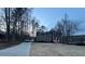 Traditional two-story home featuring a manicured lawn, long driveway, and waterfront views at 25 Clay Ct, Hiram, GA 30141