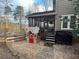 Charming home exterior featuring a screened porch and a quaint playhouse in the yard at 25 Clay Ct, Hiram, GA 30141