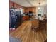 Spacious kitchen features wood cabinets, stainless appliances, island, and hardwood floors at 25 Clay Ct, Hiram, GA 30141