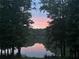 Peaceful lake view at dusk with a pink-hued sky reflecting on the water at 25 Clay Ct, Hiram, GA 30141