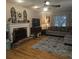 Cozy living room features a brick fireplace, hardwood floors, and comfortable seating at 25 Clay Ct, Hiram, GA 30141
