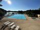 Resort-style swimming pool with lounge chairs overlooking a serene lake, perfect for relaxation and recreation at 25 Clay Ct, Hiram, GA 30141