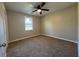 The cozy bedroom features soft carpet and a bright window, providing a comfortable retreat at 25 Oak Crest Ct, Covington, GA 30016