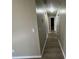 Well-lit hallway with smooth floors, providing access to various rooms in the home at 25 Oak Crest Ct, Covington, GA 30016