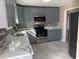 Modern kitchen featuring stainless steel appliances, ample counter space, and gray cabinets at 25 Oak Crest Ct, Covington, GA 30016