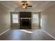 Spacious living room features a stone fireplace, tray ceilings, and dual windows that provide natural light at 25 Oak Crest Ct, Covington, GA 30016