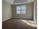 Spacious bedroom featuring soft carpet and a bright window, offering a comfortable living space at 25 Oak Crest Ct, Covington, GA 30016