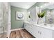 Bright bathroom featuring double sinks, white cabinets, and a glass enclosed shower at 81 Heritage Pointe Dr, Villa Rica, GA 30180