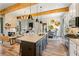 Open-concept kitchen with granite counters, stainless appliances, island with seating, and a view to the living area at 81 Heritage Pointe Dr, Villa Rica, GA 30180