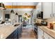 Bright kitchen with granite countertops, stainless steel appliances, island, and adjoining dining and living areas at 81 Heritage Pointe Dr, Villa Rica, GA 30180