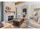 Living room featuring a stone fireplace, wooden beams, and stylish modern furniture at 81 Heritage Pointe Dr, Villa Rica, GA 30180