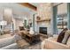 Living room showcases a stone fireplace, wood beams, and a view of the staircase at 81 Heritage Pointe Dr, Villa Rica, GA 30180