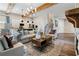 Bright living room with stone fireplace and open floor plan leading to the kitchen at 81 Heritage Pointe Dr, Villa Rica, GA 30180