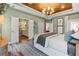 Bright main bedroom with a decorative wood tray ceiling, leading into the ensuite bathroom at 81 Heritage Pointe Dr, Villa Rica, GA 30180