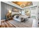 Serene main bedroom with stylish decor, wood-paneled ceiling, chandelier, and lots of natural light at 81 Heritage Pointe Dr, Villa Rica, GA 30180