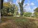 View of the backyard with abundant greenery and mature trees at 4239 Newcomb Rd, Decatur, GA 30034