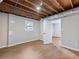 Basement area featuring unfinished ceilings, a window and a door at 4239 Newcomb Rd, Decatur, GA 30034
