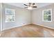 Bright bedroom featuring two windows, a ceiling fan, wood floors and neutral paint at 4239 Newcomb Rd, Decatur, GA 30034