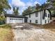 Exterior of home with an attached garage and a long drive at 4239 Newcomb Rd, Decatur, GA 30034