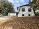 Quaint two-story house with attached garage and a long driveway at 4239 Newcomb Rd, Decatur, GA 30034